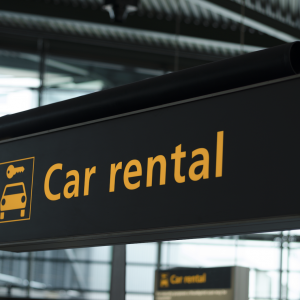Car rental sign at an airport; auto insurance. 